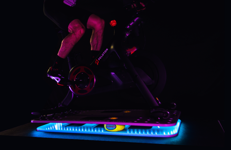 Man riding Velocity Rocker Spin with LED lights illuminating.