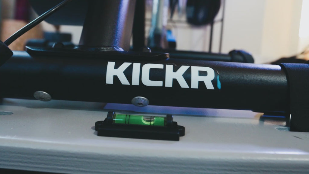 Indoor cycling using the Kickr Core smart trainer on top of the Velocity Rocker rocker plate showing a close up of the bubble moving inside the spirit level as the rocker plate rocks side-to-side.