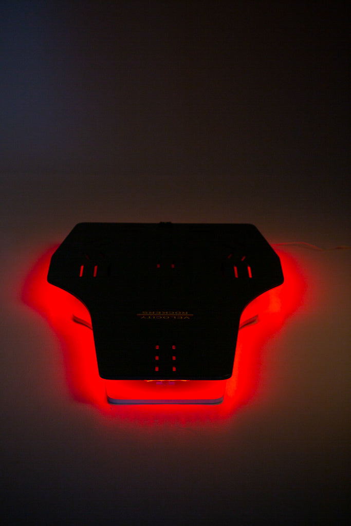 Velocity Rocker rocker plate lit up with LED lights in red color.